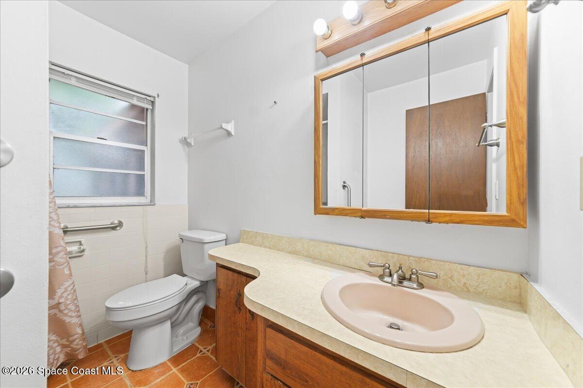 2066 Acacia Street Northeast Palm Bay, FL 32905 - Photo 18 of 28 a bathroom with a sink toilet and shower