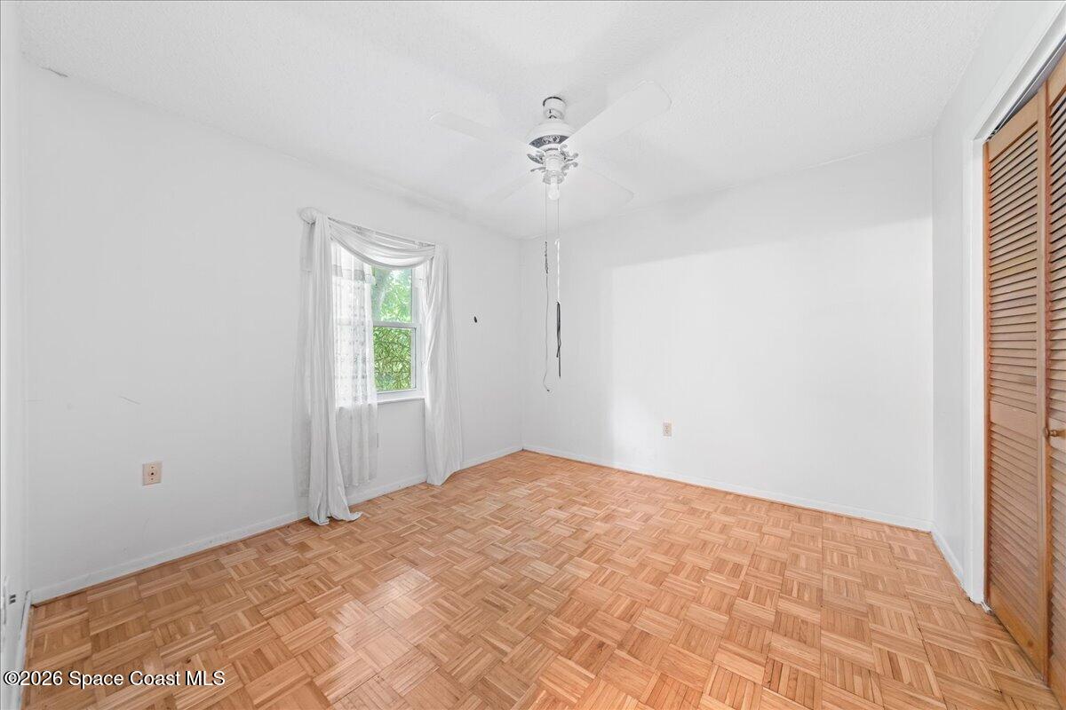 2066 Acacia Street Northeast Palm Bay, FL 32905 - Photo 19 of 28 a view of a big room with windows and chandelier fan