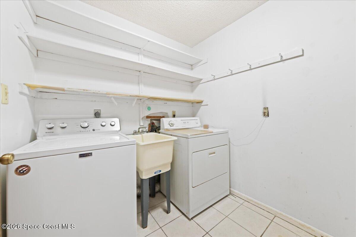 2066 Acacia Street Northeast Palm Bay, FL 32905 - Photo 24 of 28 a utility room with dryer and washer