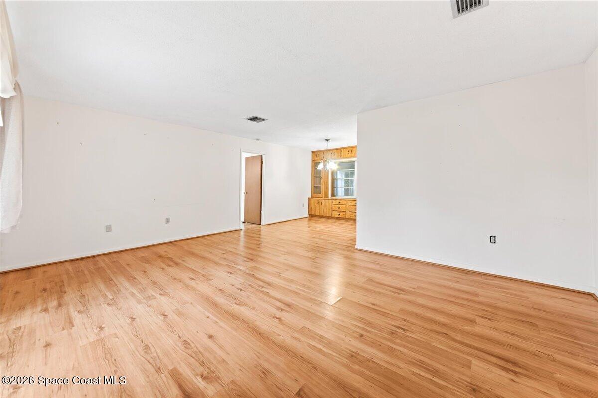 2066 Acacia Street Northeast Palm Bay, FL 32905 - Photo 8 of 28 a view of an empty room and wooden floor