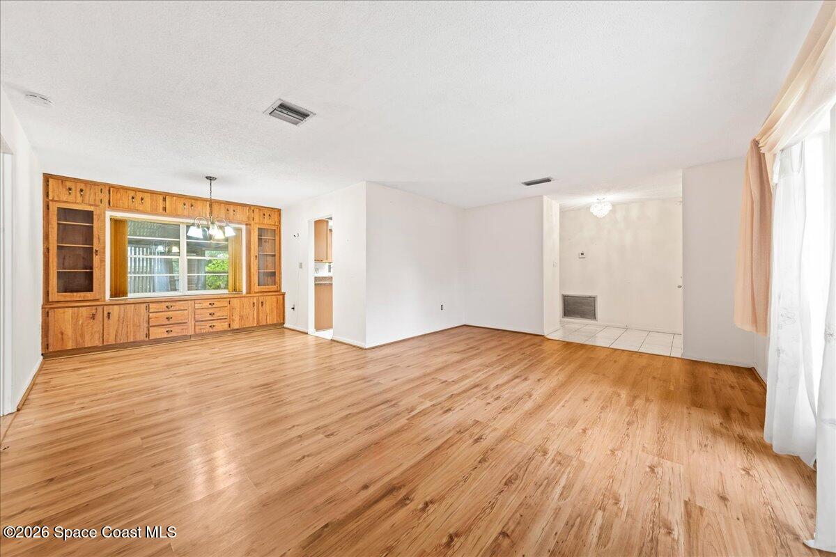 2066 Acacia Street Northeast Palm Bay, FL 32905 - Photo 9 of 28 a view of empty room with wooden floor and fan