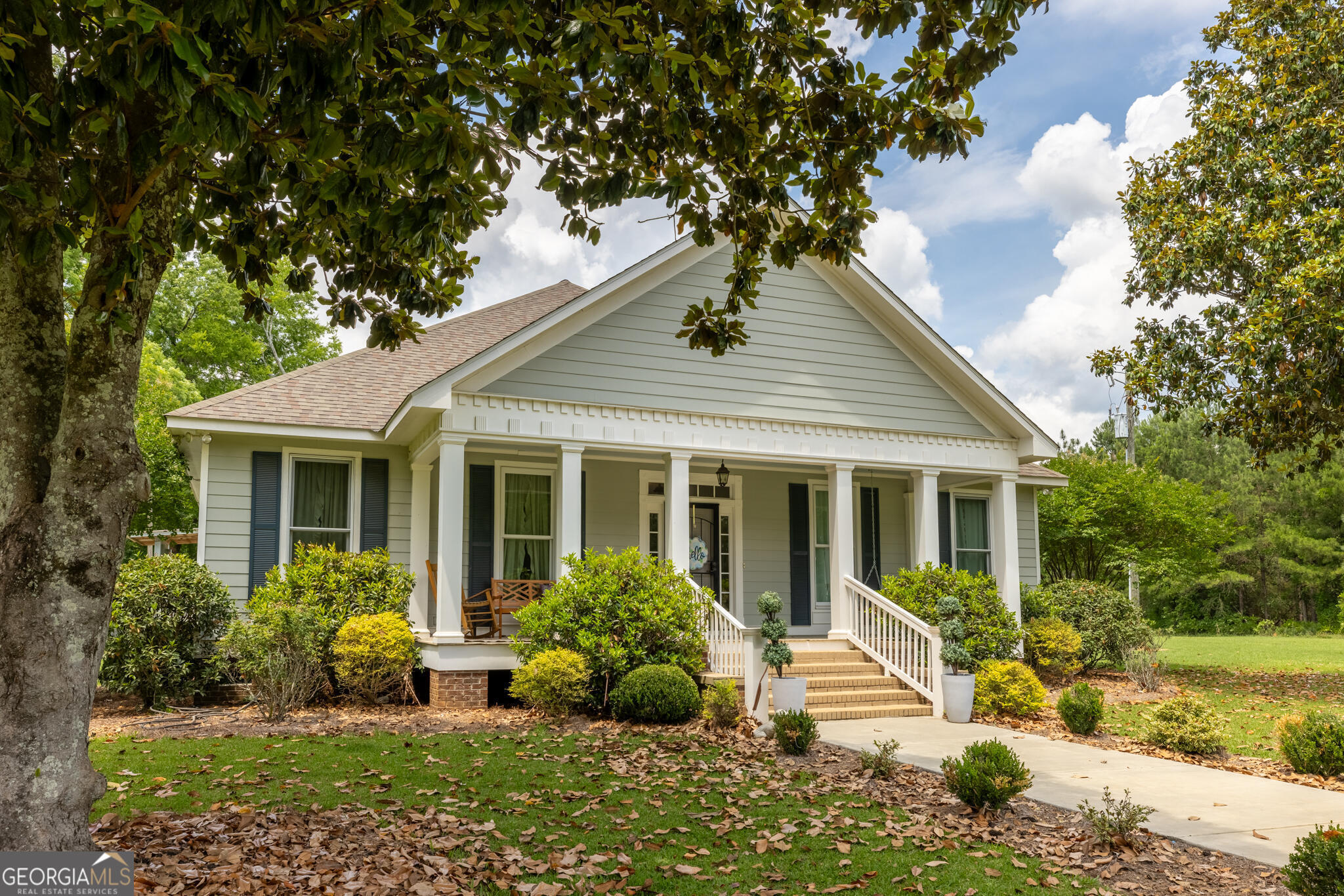 1859 Upper River Road Americus, GA 31709 - Photo 3 of 47 a front view of a house with a garden and plants