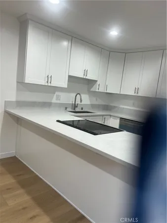 a kitchen with a sink and cabinets