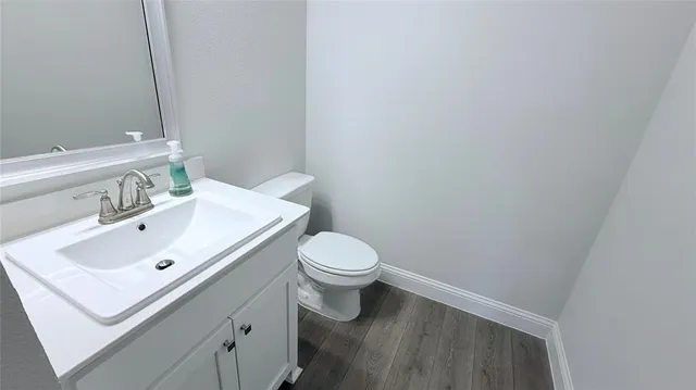 a bathroom with a sink mirror and toilet