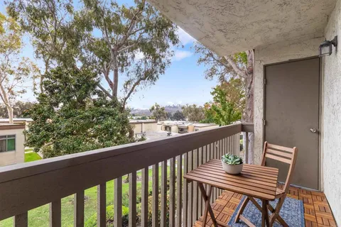 a view of balcony with wooden floor and fence