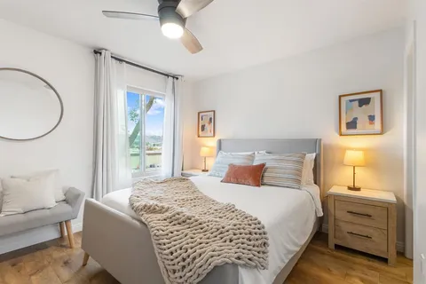 a bedroom with a bed and a chandelier