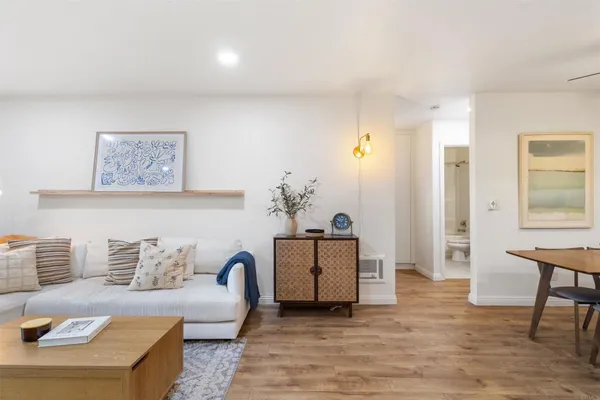 a living room with furniture and wooden floor