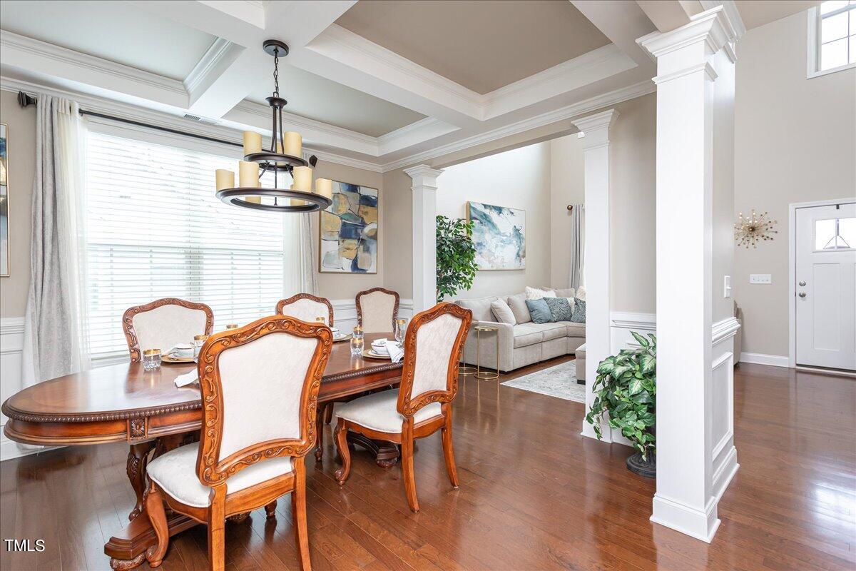 7656 Channery Way Raleigh, NC 27616 - Photo 11 of 44 a view of a dining room with furniture wooden floor and chandelier