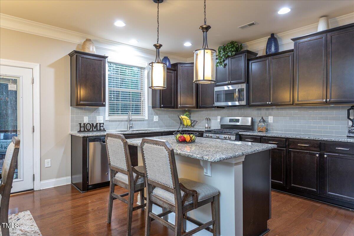 7656 Channery Way Raleigh, NC 27616 - Photo 12 of 44 a kitchen with a sink stove and refrigerator