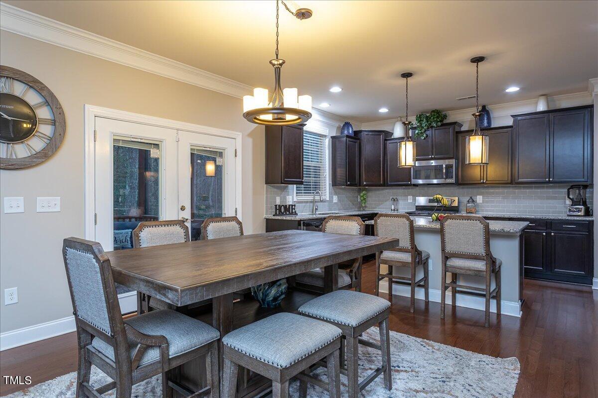 7656 Channery Way Raleigh, NC 27616 - Photo 14 of 44 a dining table with chairs and kitchen view