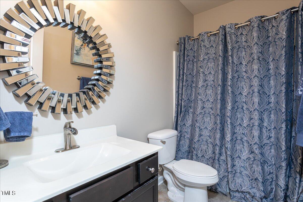 7656 Channery Way Raleigh, NC 27616 - Photo 22 of 44 a bathroom with a sink a toilet and a mirror