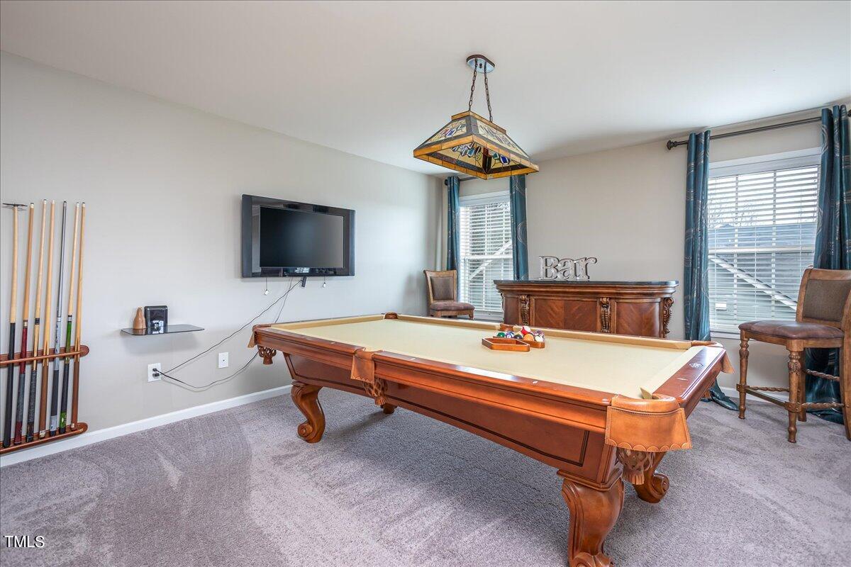 7656 Channery Way Raleigh, NC 27616 - Photo 23 of 44 a living room with furniture and a flat screen tv