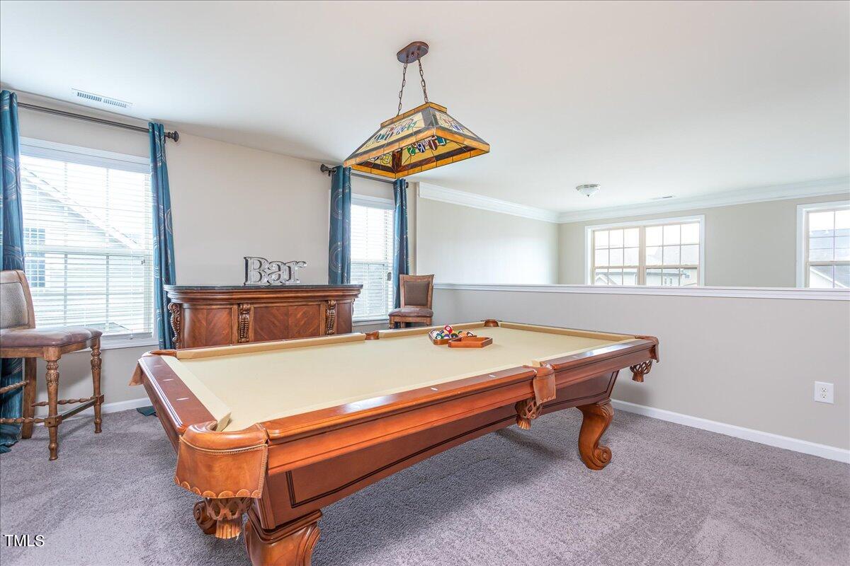 7656 Channery Way Raleigh, NC 27616 - Photo 24 of 44 a room with pool table and windows