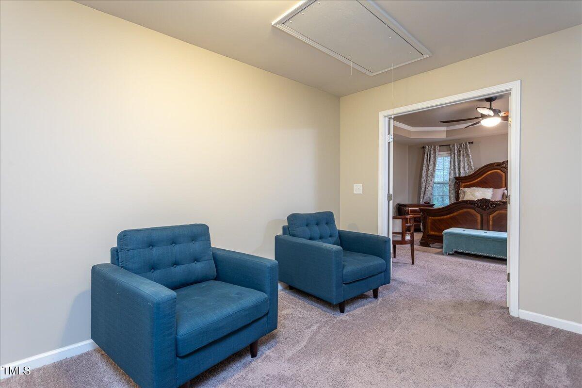7656 Channery Way Raleigh, NC 27616 - Photo 25 of 44 a living room with furniture and a mirror