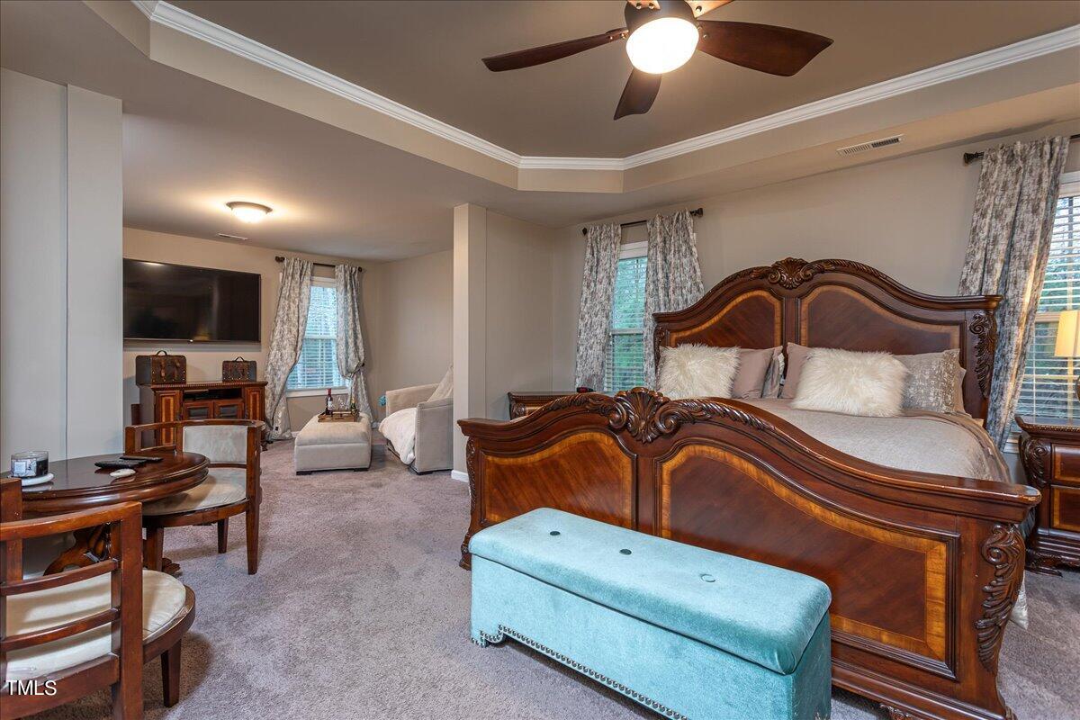 7656 Channery Way Raleigh, NC 27616 - Photo 26 of 44 a living room with furniture a ceiling fan and a window