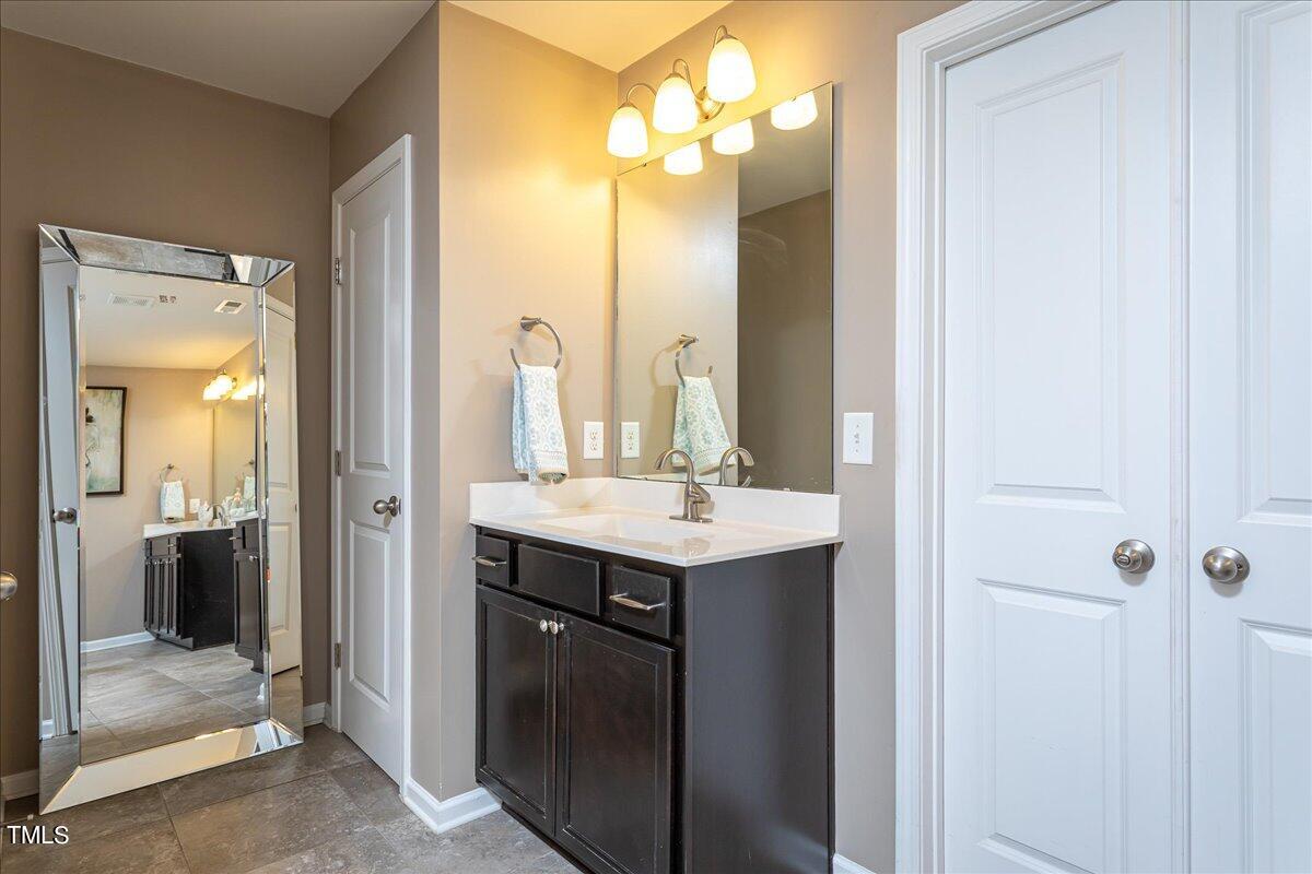 7656 Channery Way Raleigh, NC 27616 - Photo 29 of 44 a bathroom with a sink vanity and a mirror
