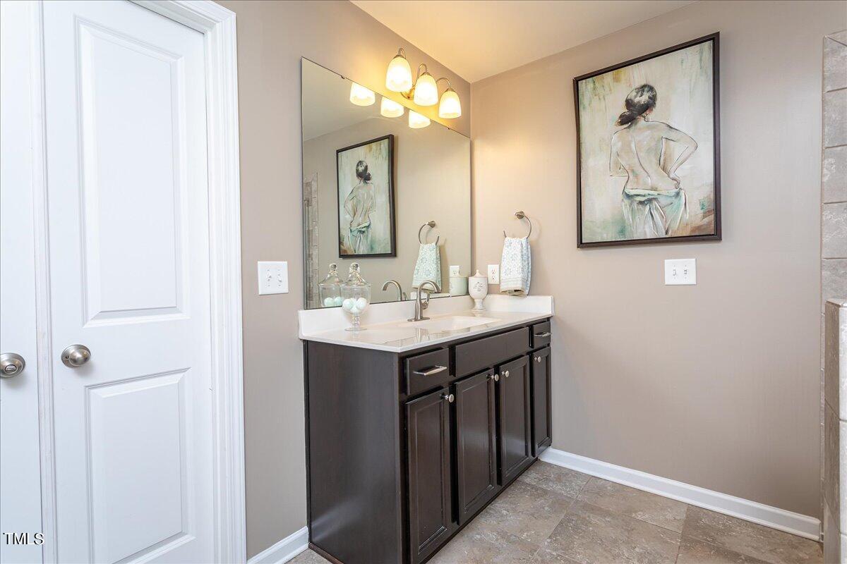 7656 Channery Way Raleigh, NC 27616 - Photo 30 of 44 a bathroom with a sink and a mirror