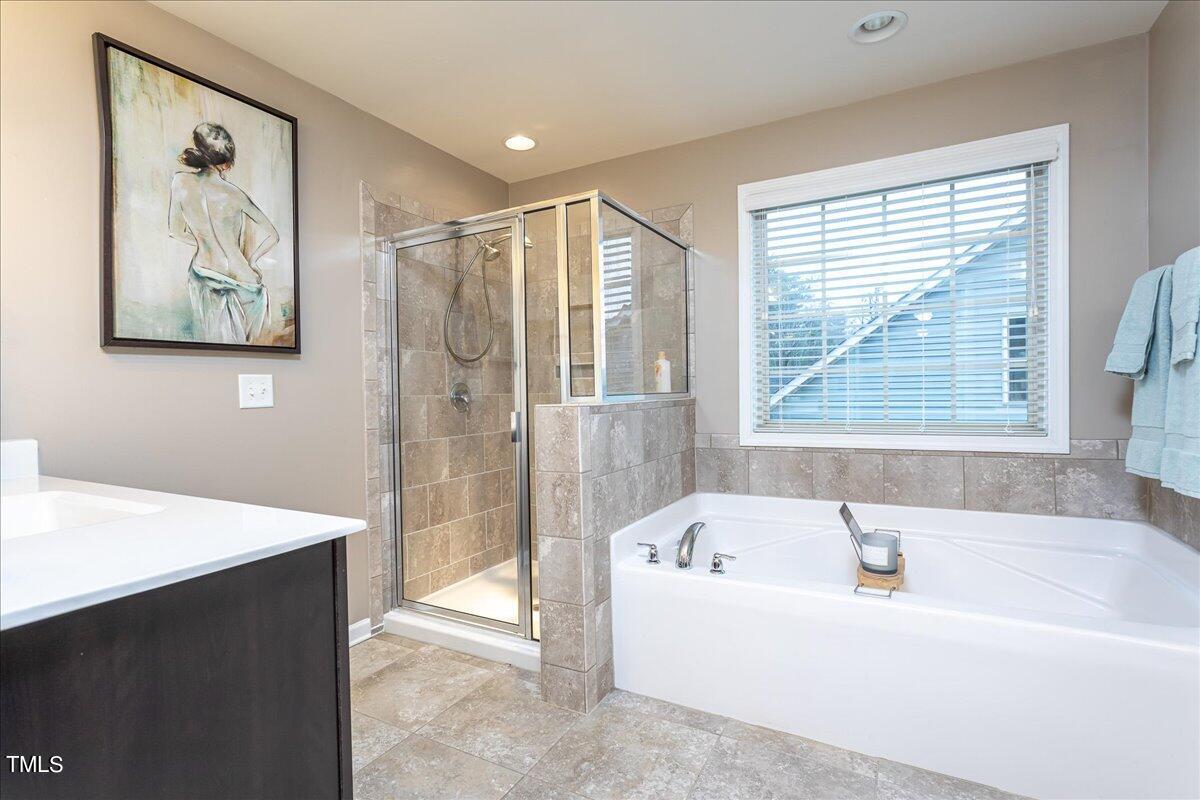 7656 Channery Way Raleigh, NC 27616 - Photo 31 of 44 a bathroom with a bathtub and a shower