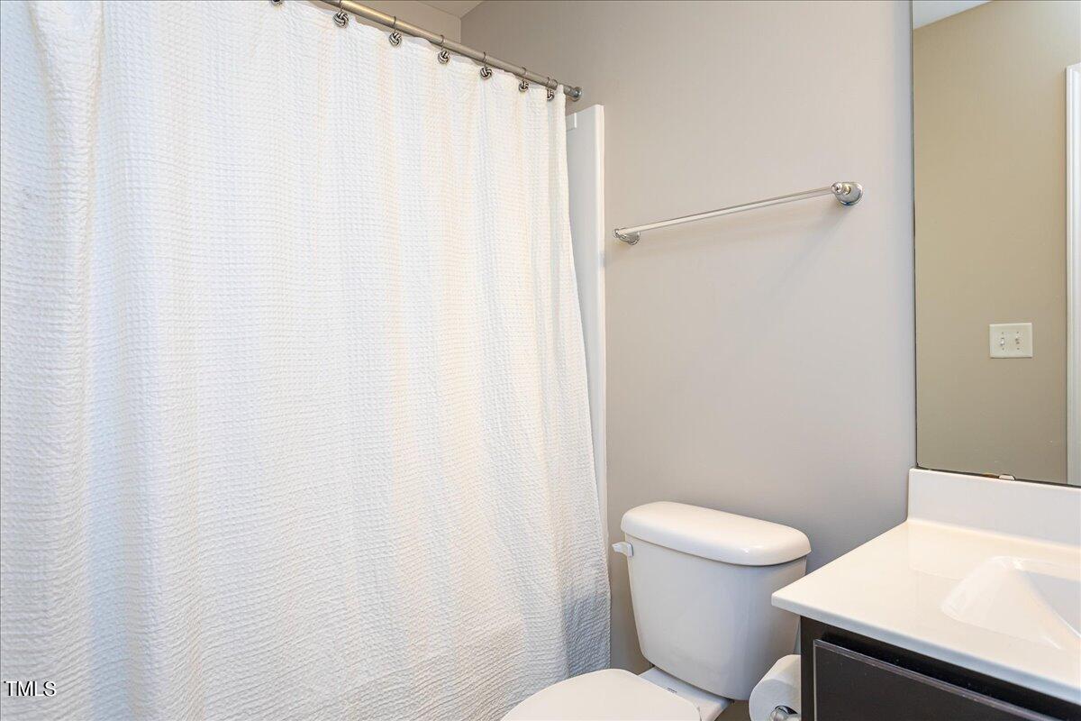 7656 Channery Way Raleigh, NC 27616 - Photo 33 of 44 a white toilet sitting next to a bathroom sink