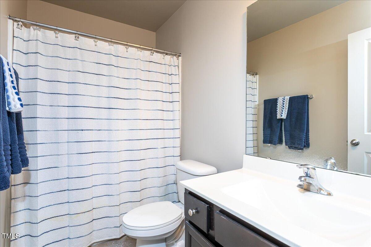 7656 Channery Way Raleigh, NC 27616 - Photo 35 of 44 a bathroom with a sink toilet and shower