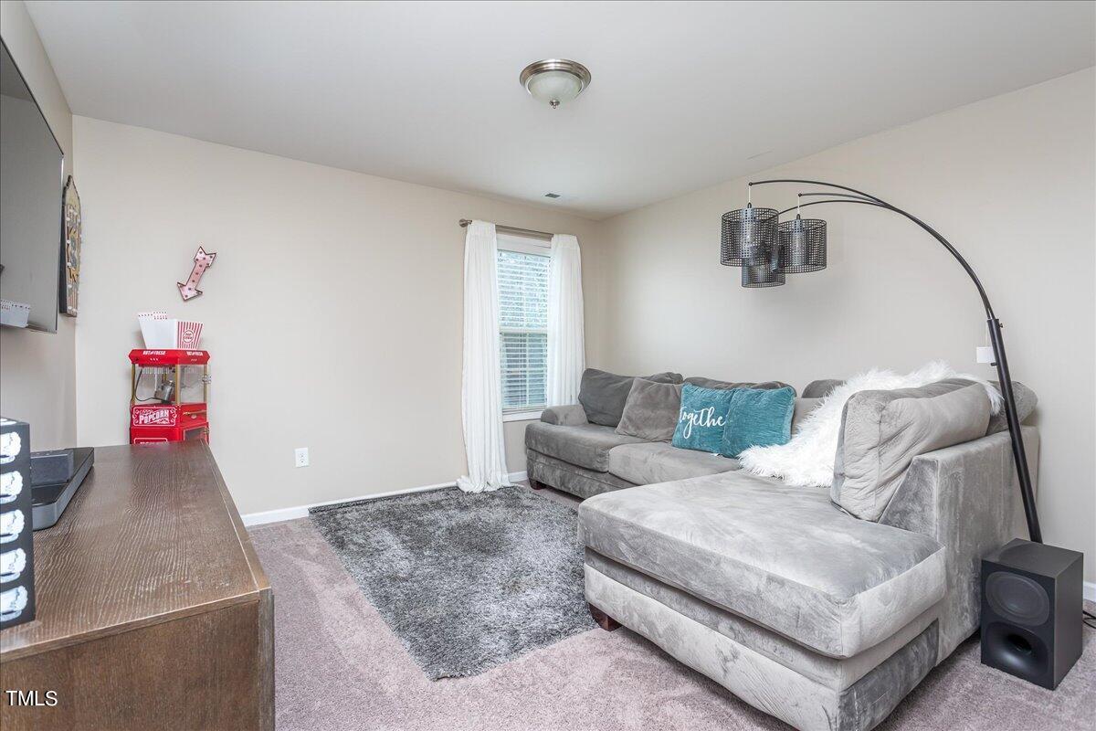 7656 Channery Way Raleigh, NC 27616 - Photo 36 of 44 a living room with furniture and a couch