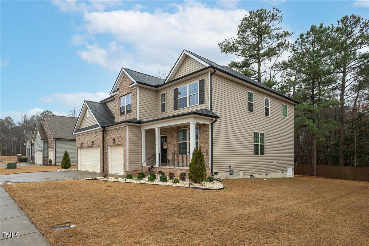 7656 Channery Way Raleigh, NC 27616 - Photo 4 of 44 a front view of a house with a yard and garage