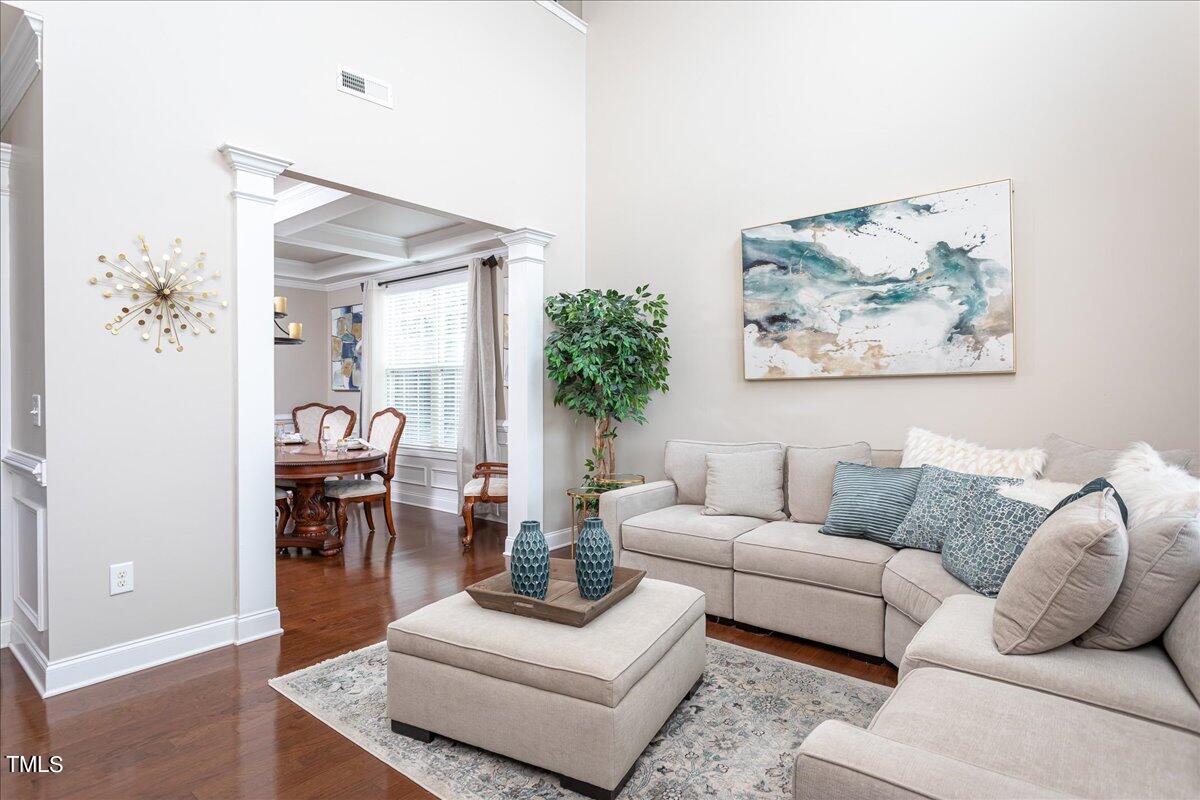 7656 Channery Way Raleigh, NC 27616 - Photo 9 of 44 a living room with furniture and a painting on the wall