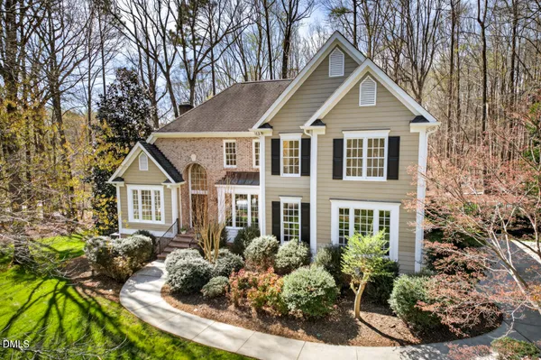 a front view of a house with a garden