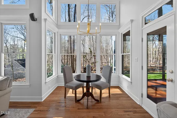 a living room with a bed furniture and next to a window