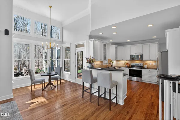 a bedroom with a bed a couch and large window