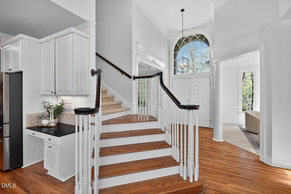 a bathroom with a sink a mirror and a potted plant