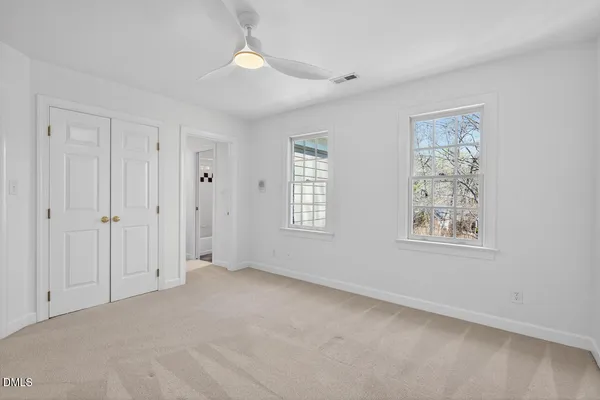 an aerial view of a house with a yard and large trees