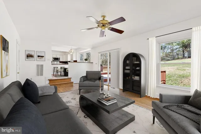 a view of a living room hardwood floor and a window