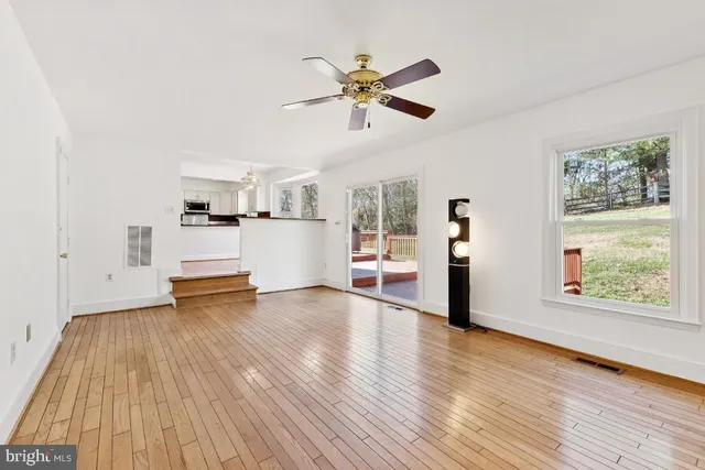 a view of a room with wooden floor