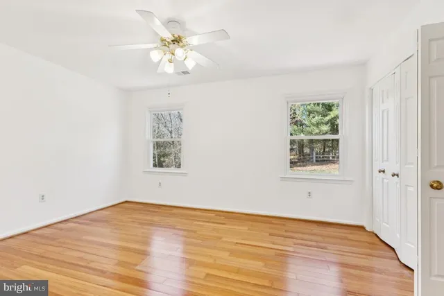 a spacious bedroom with a bed and a flat screen tv