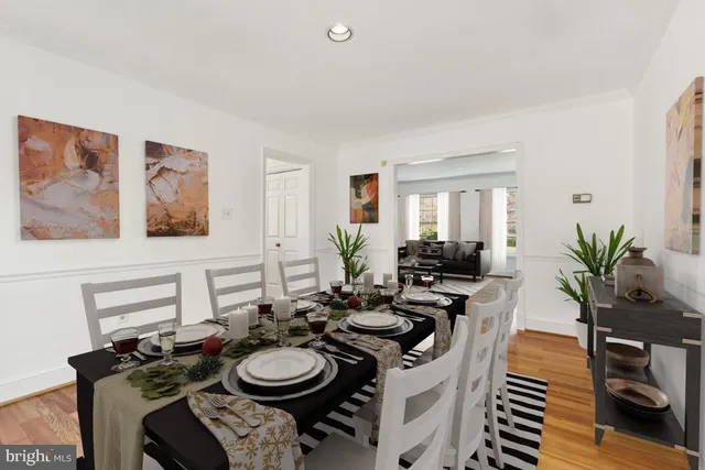 a dining room with furniture and wooden floor