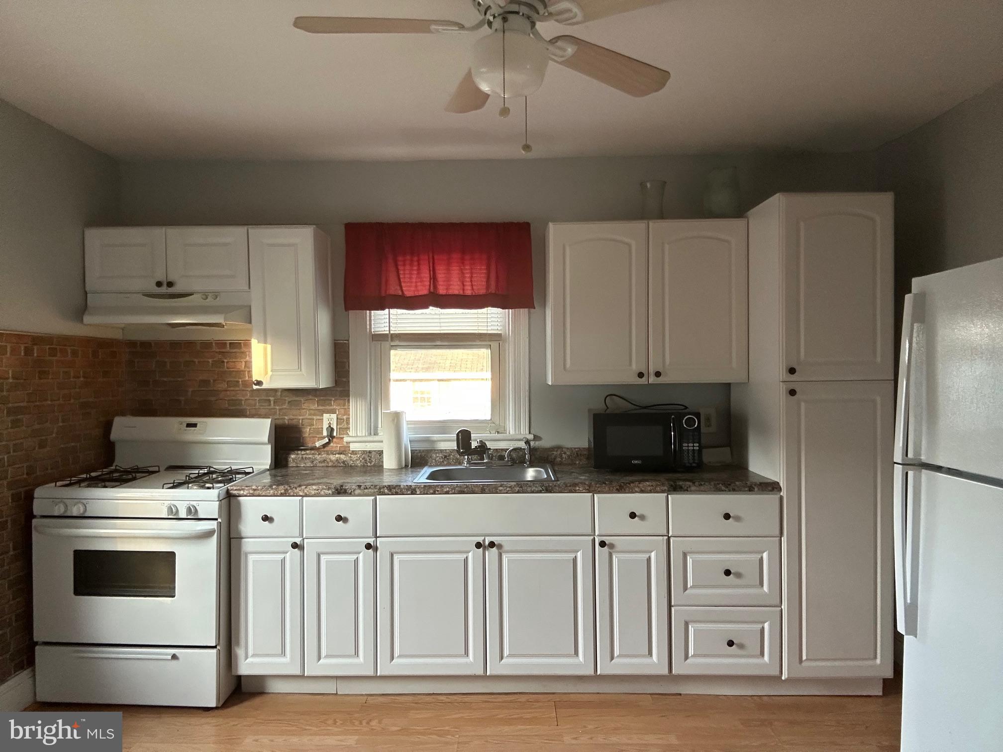 126 Delaware Avenue, Unit B Riverside, NJ 08075 - Photo 3 of 9 a kitchen with stainless steel appliances a stove a sink and a refrigerator