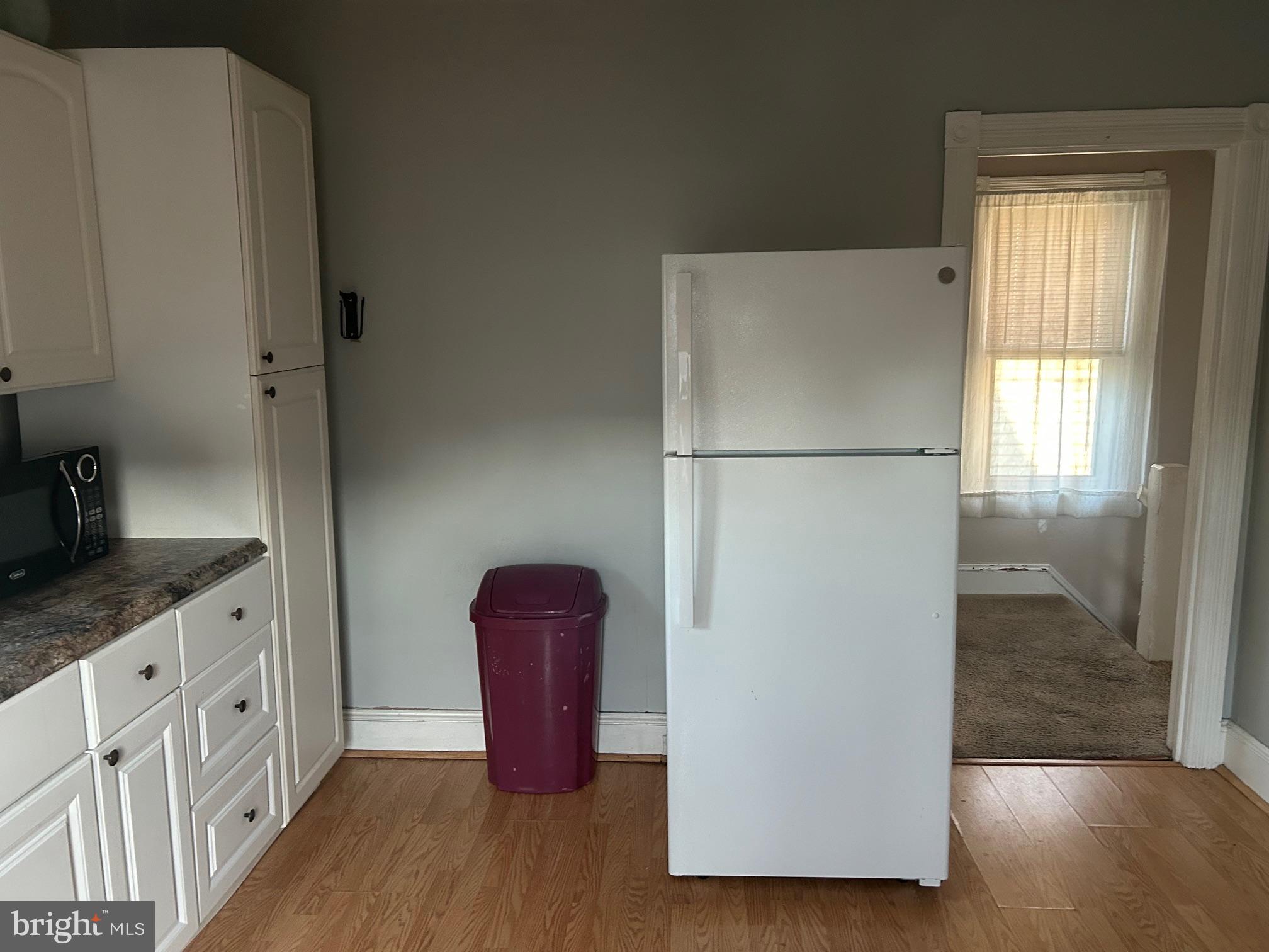 126 Delaware Avenue, Unit B Riverside, NJ 08075 - Photo 4 of 9 a white refrigerator freezer and a wooden floor