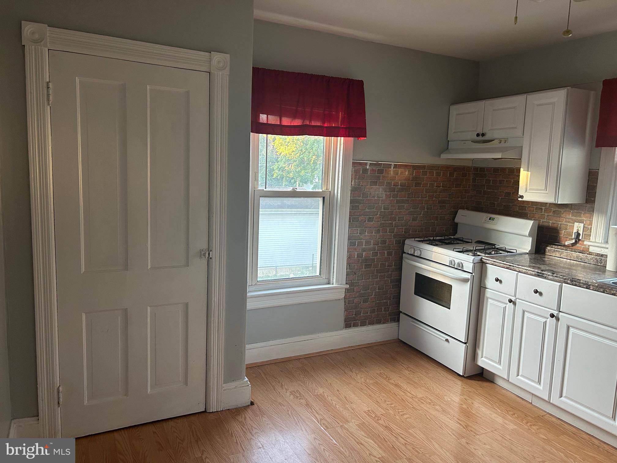 126 Delaware Avenue, Unit B Riverside, NJ 08075 - Photo 5 of 9 a kitchen with granite countertop white cabinets and white appliances