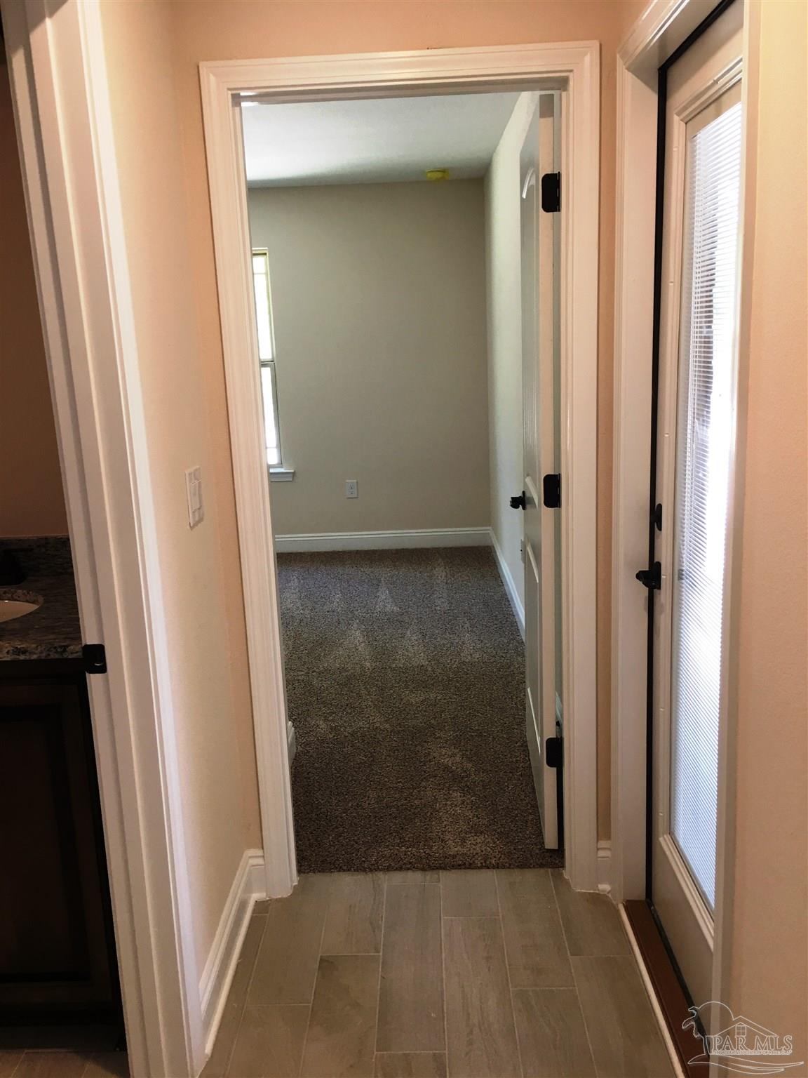 5430 South A Jones Road Milton, FL 32583 - Photo 22 of 27 Back hall leads to 2 bedrooms/1 bath & patio.