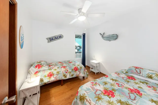 a bedroom with two beds and a dresser