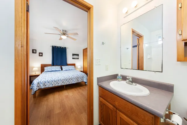a en suite bathroom with a granite countertop sink and a mirror