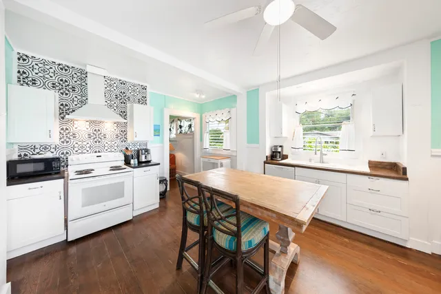 a kitchen with white cabinets and white appliances