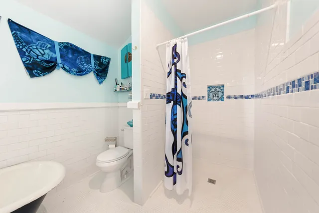 a bathroom with a toilet sink and shower