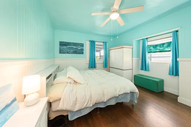 a bedroom with a bed mirror and a window