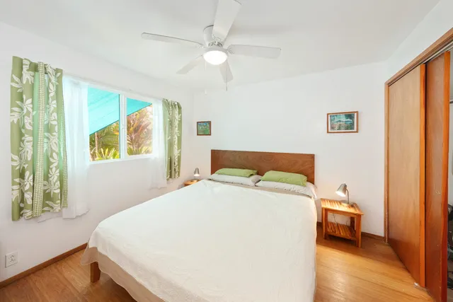 a bedroom with a bed and a large window