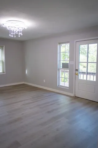a backyard of a house with barbeque oven table and chairs