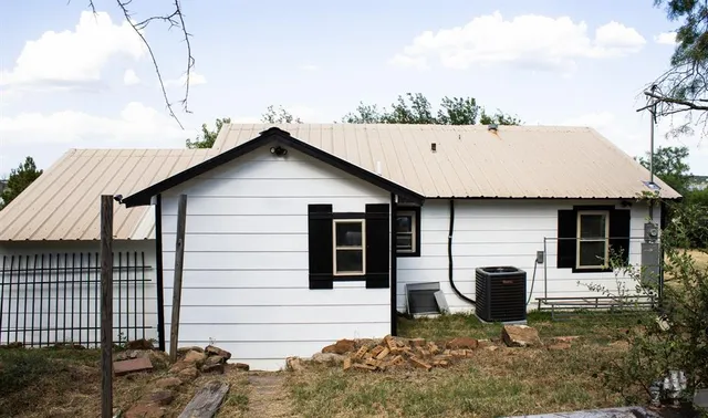 a view of a house with a wooden deck