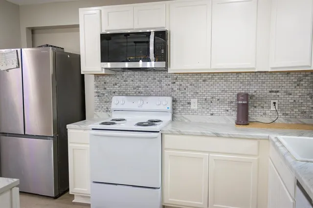 a kitchen with a refrigerator sink and microwave