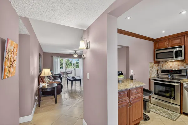a kitchen with stainless steel appliances granite countertop a sink stove and microwave